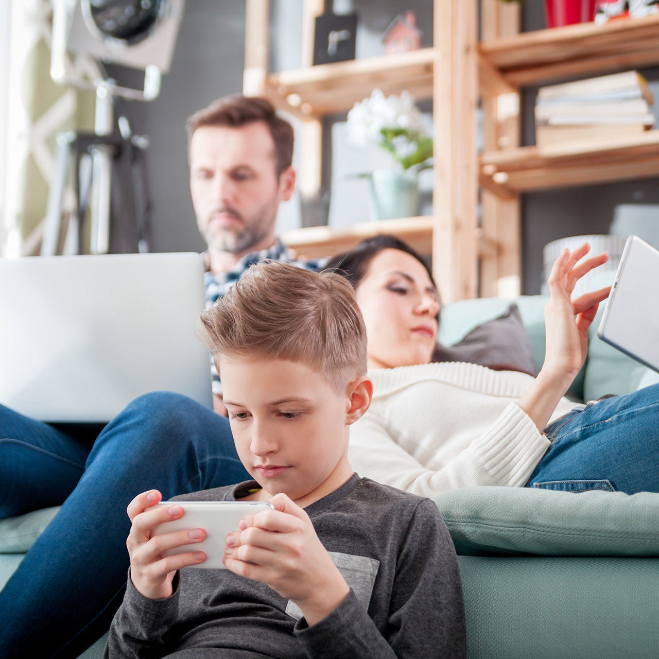 Family in living room with devices
